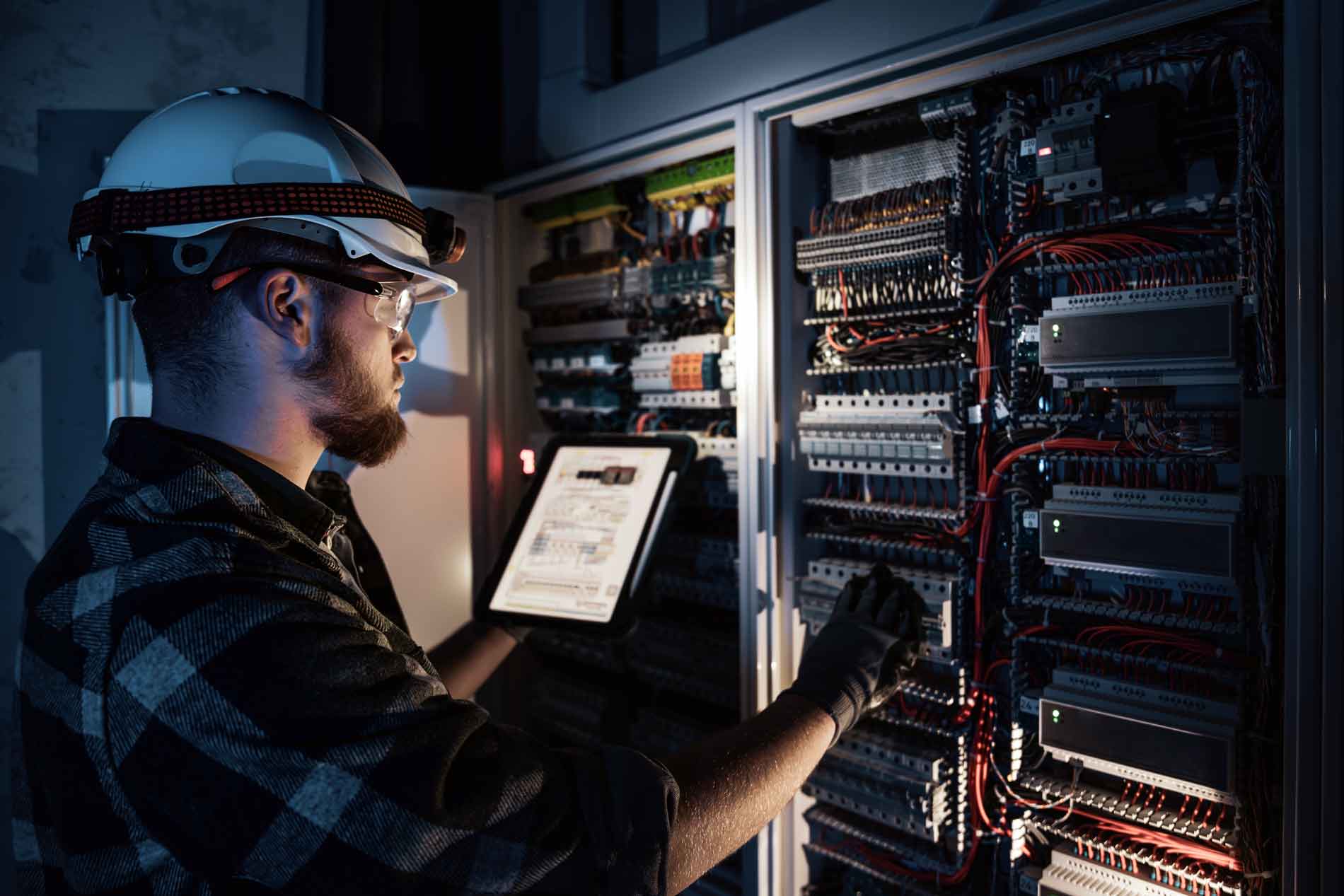 Commercial electrician performing emergency electrical maintenance